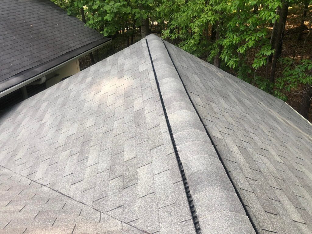 Close-up of a completed asphalt shingle roof ridge