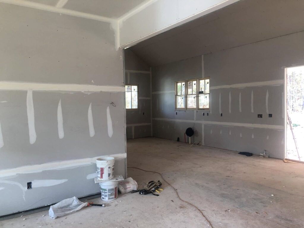 Sheetrock installation during a home remodel by Roof Works