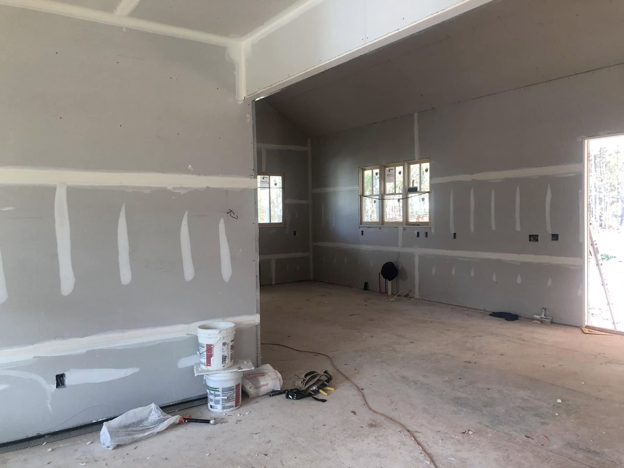 Sheetrock installation during a home remodel by Roof Works