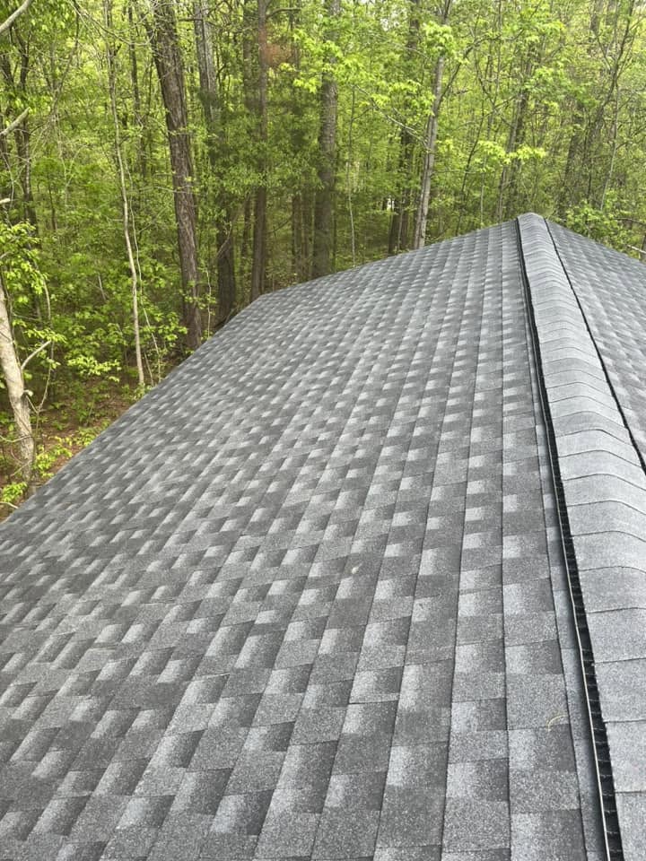 Close-up of a completed asphalt shingle roof ridge