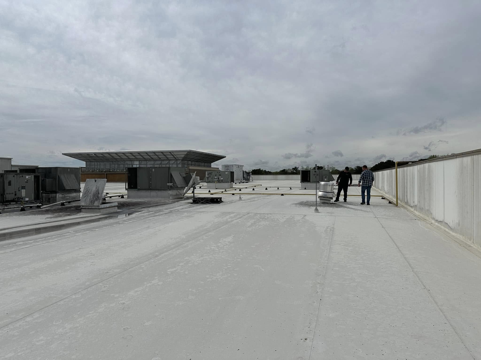 The Roof Works team on a completed commercial TPO roof