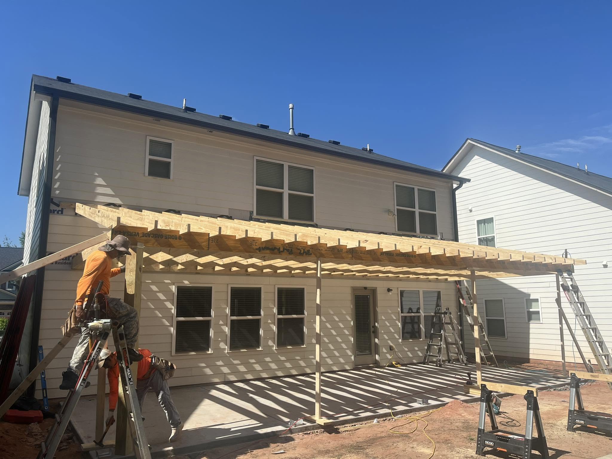 Roof Works crew framing a porch cover during residential construction on a NW Georgia home