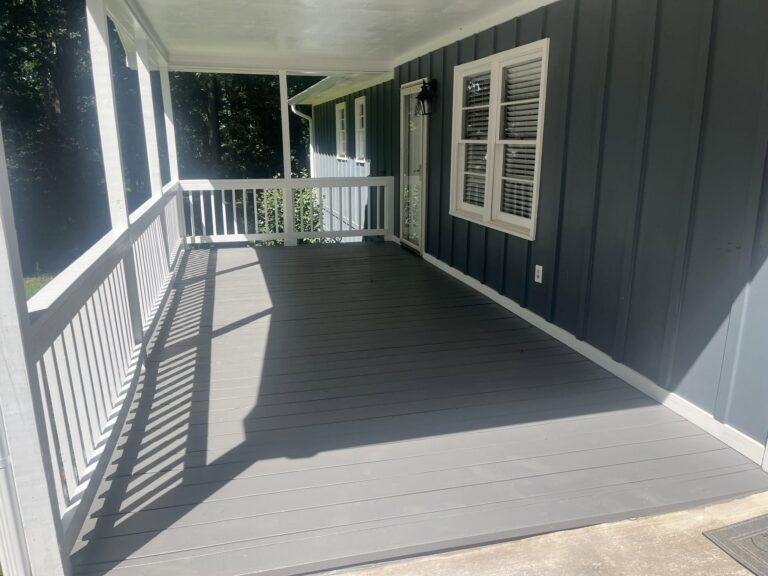 Finished deck and porch build-out with a white rail, by Roof Works