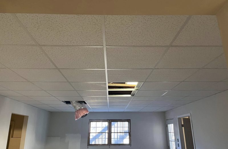 Drop-tile ceiling grid being installed by Roof Works