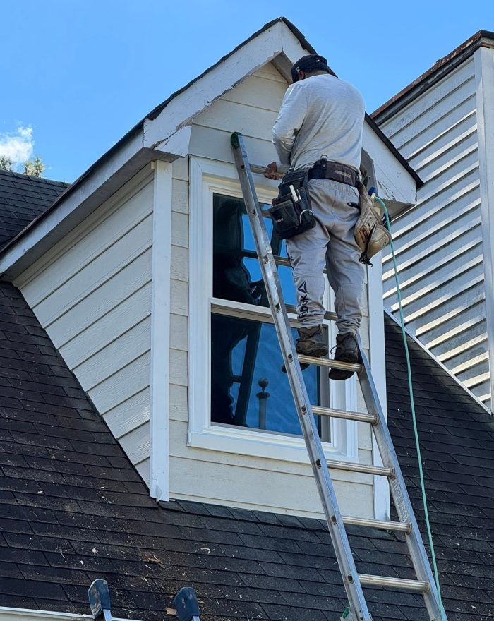A Roof Works crew member fitting a dormer window