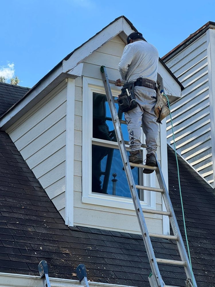 A Roof Works crew member fitting a dormer window