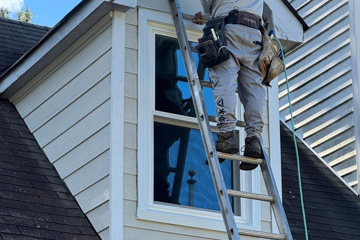 A Roof Works crew member fitting a dormer window