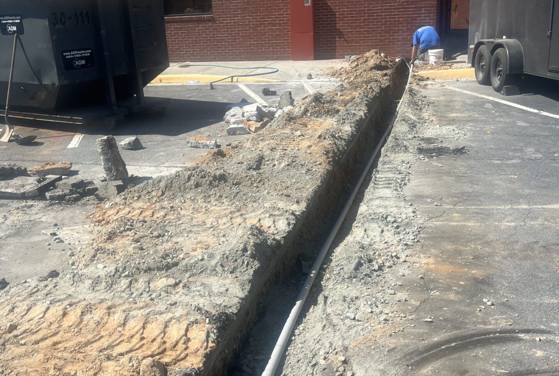 Paving cut and excavated in preparation for a new concrete pour by Roof Works